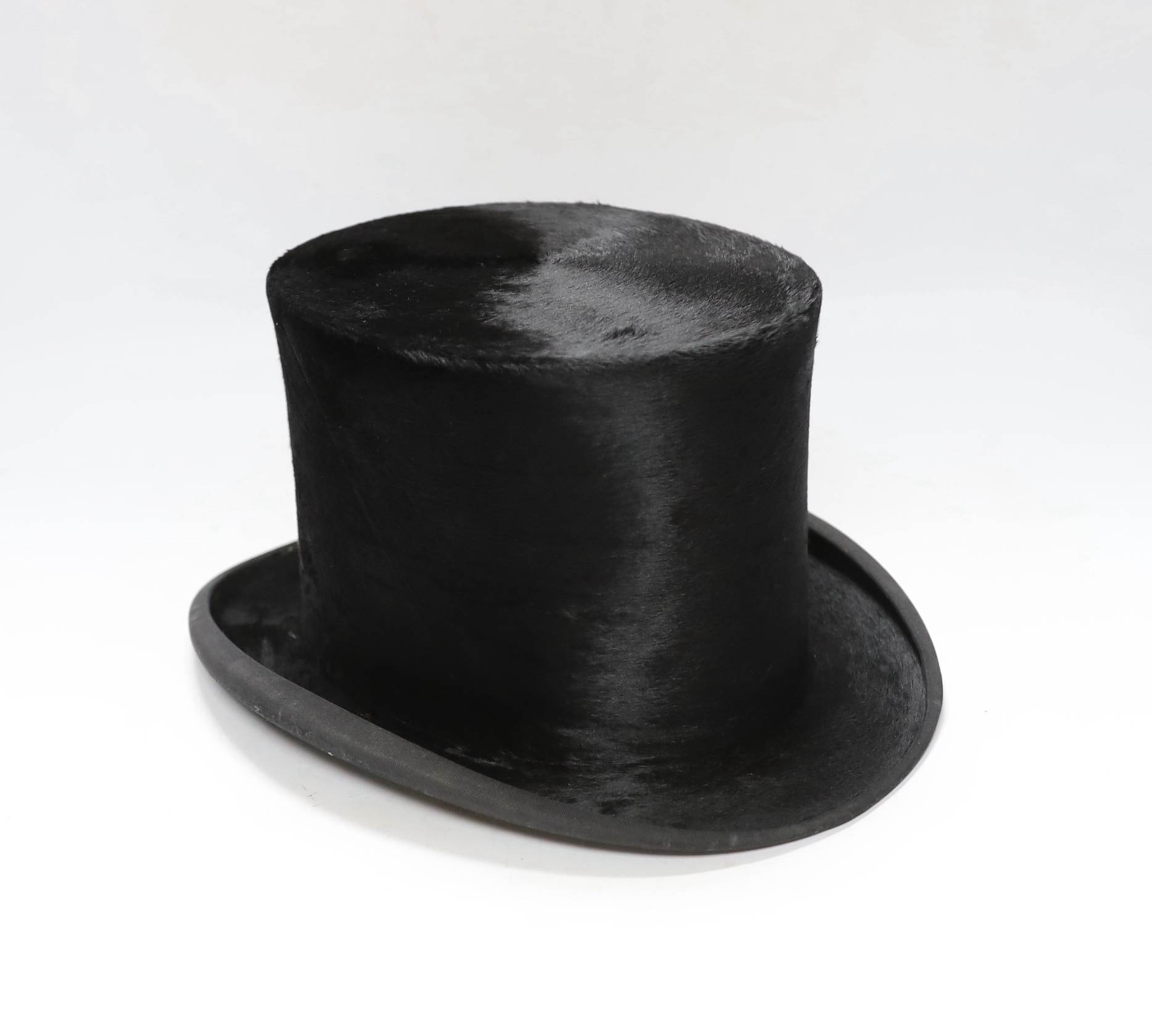 A brown leather case and top hat, hat box 24cm high